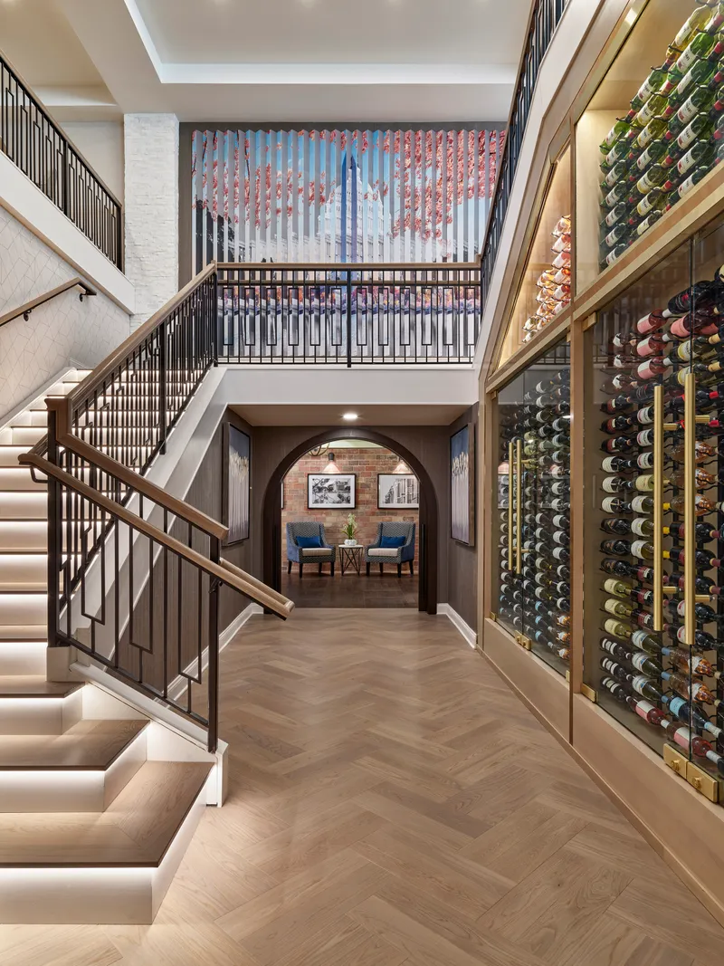 Renovated lobby with a grand staircase and herringbone floor